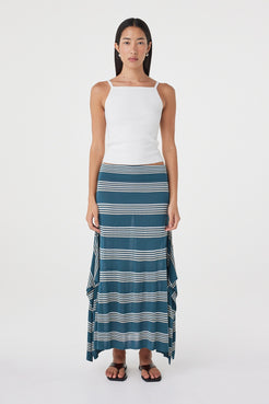 Front view of the Lex Skirt in Teal Stripe featuring a custom stripe print, elasticated waistband and flowing handkerchief silhouette, styled with a white tank.