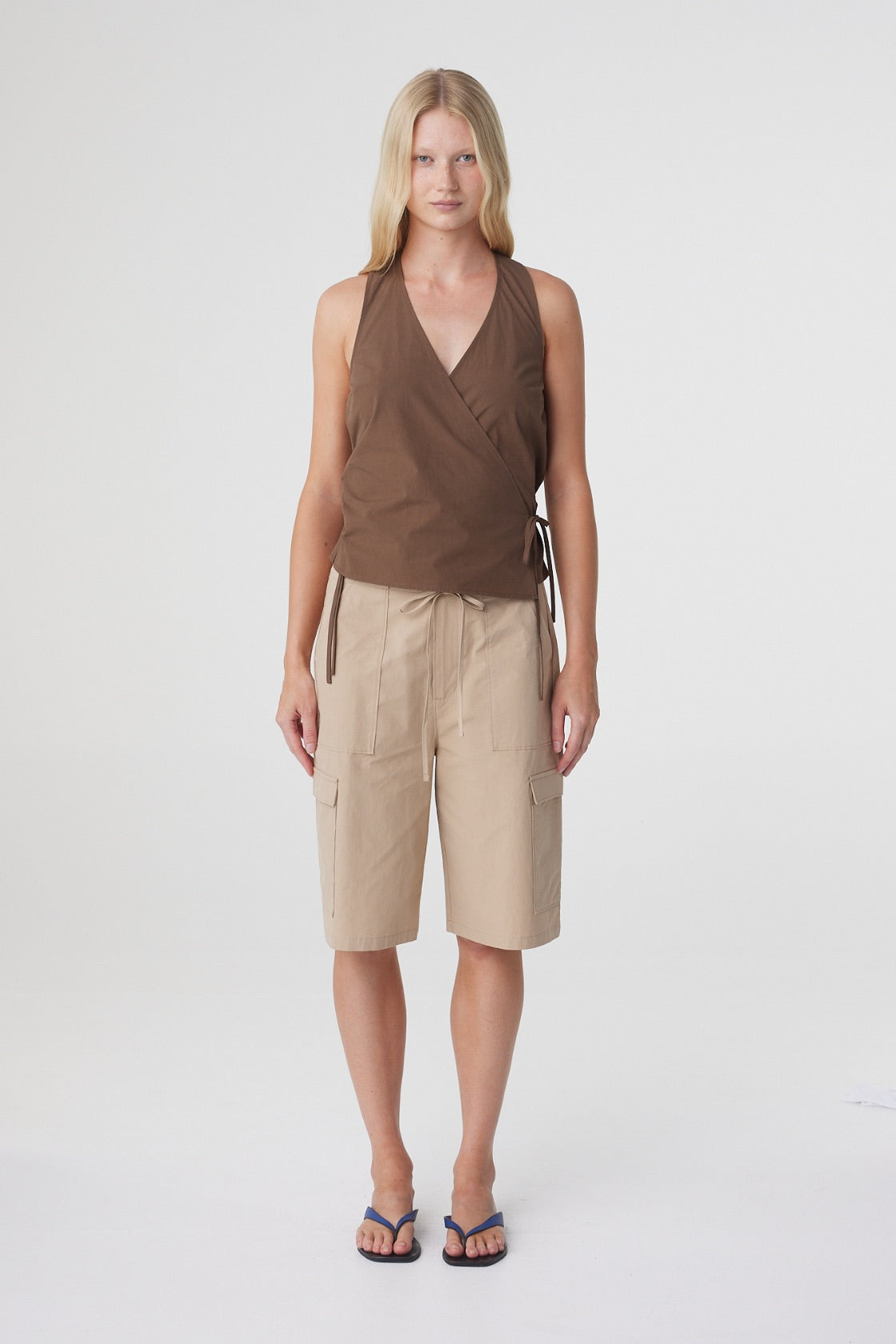 Daria Short in Camel, full front view styled with the Lilia Wrap Top in Espresso, showing the relaxed knee length silhouette.