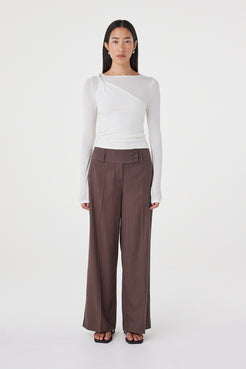 Front view of the Manon Pant in Espresso Pinstripe featuring a tailored wide-leg silhouette, three-button waistband and soft structured fabrication, styled with a white fitted top.