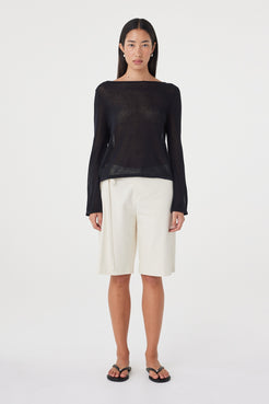 Front full-length view of the Lucia Tie Bermuda Short in Bone featuring a relaxed knee-length silhouette and double tie waist, styled with a black long sleeve top.