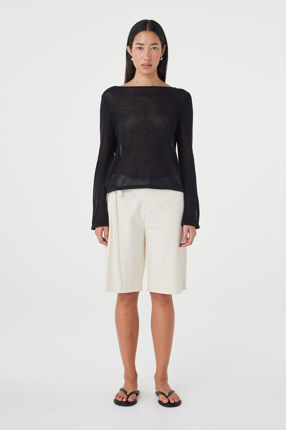 Front full-length view of the Lucia Tie Bermuda Short in Bone featuring a relaxed knee-length silhouette and double tie waist, styled with a black long sleeve top.