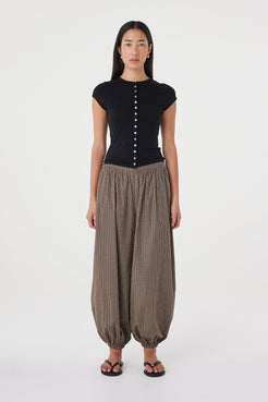 Front view of the Elina Balloon Pant in Chocolate Check featuring a relaxed balloon-leg silhouette, gathered hems and subtle micro check fabrication, styled with the Robbie Top in Black.