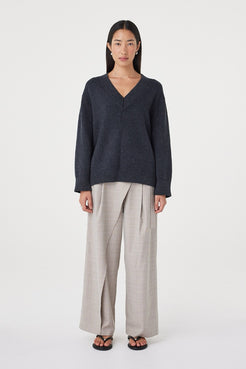 Front view of the Zenya Sweater in Dark Grey Marle showcasing the deep V-neckline, relaxed drape and textured marled knit finish.