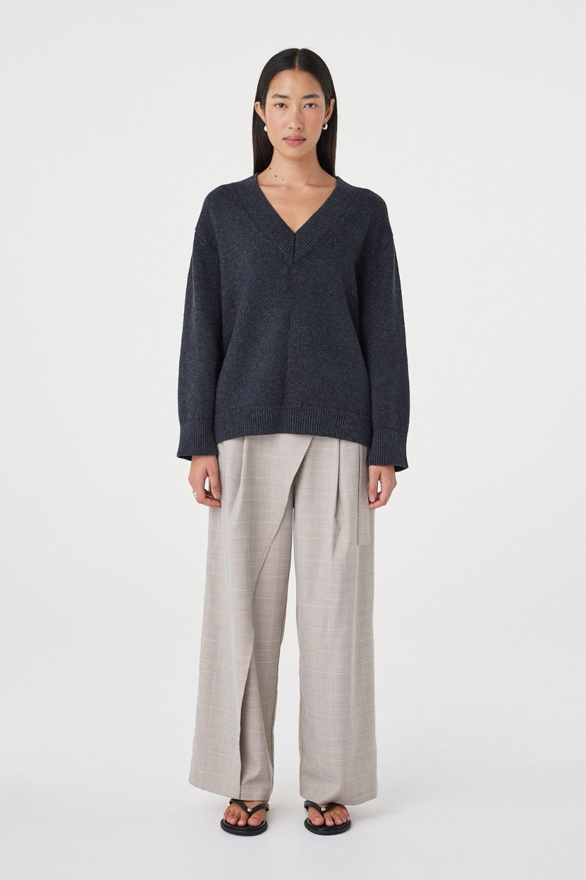 Front view of the Zenya Sweater in Dark Grey Marle showcasing the deep V-neckline, relaxed drape and textured marled knit finish.