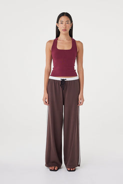 Front view of the Tully Pant in espresso and cream styled with a fitted merlot tank and black sandals, showcasing the relaxed wide-leg fit and sporty stripe detailing
