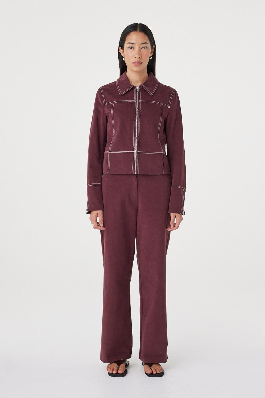 Front view of the Benny Jacket in Merlot highlighting the contrast stitch detailing, concealed pockets and clean zip closure.