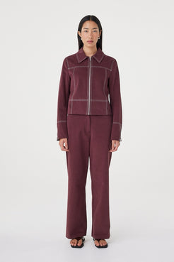 Front view of the Benny Jacket in Merlot highlighting the contrast stitch detailing, concealed pockets and clean zip closure.
