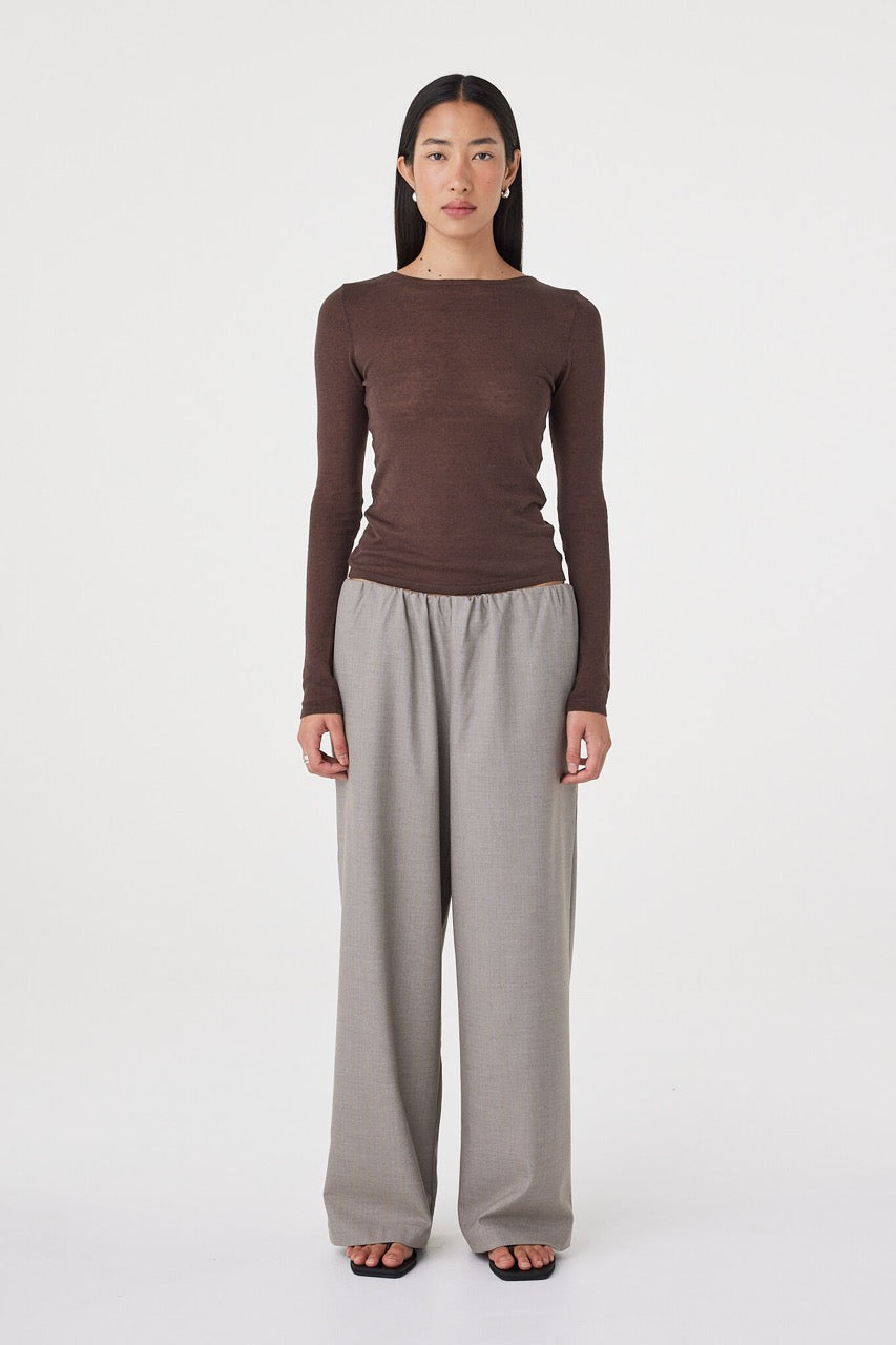 Front view of the Annika Pant in taupe blue pinstripe styled with a fitted espresso brown long sleeve top and black sandals, featuring a relaxed wide-leg silhouette and soft elasticated waistband