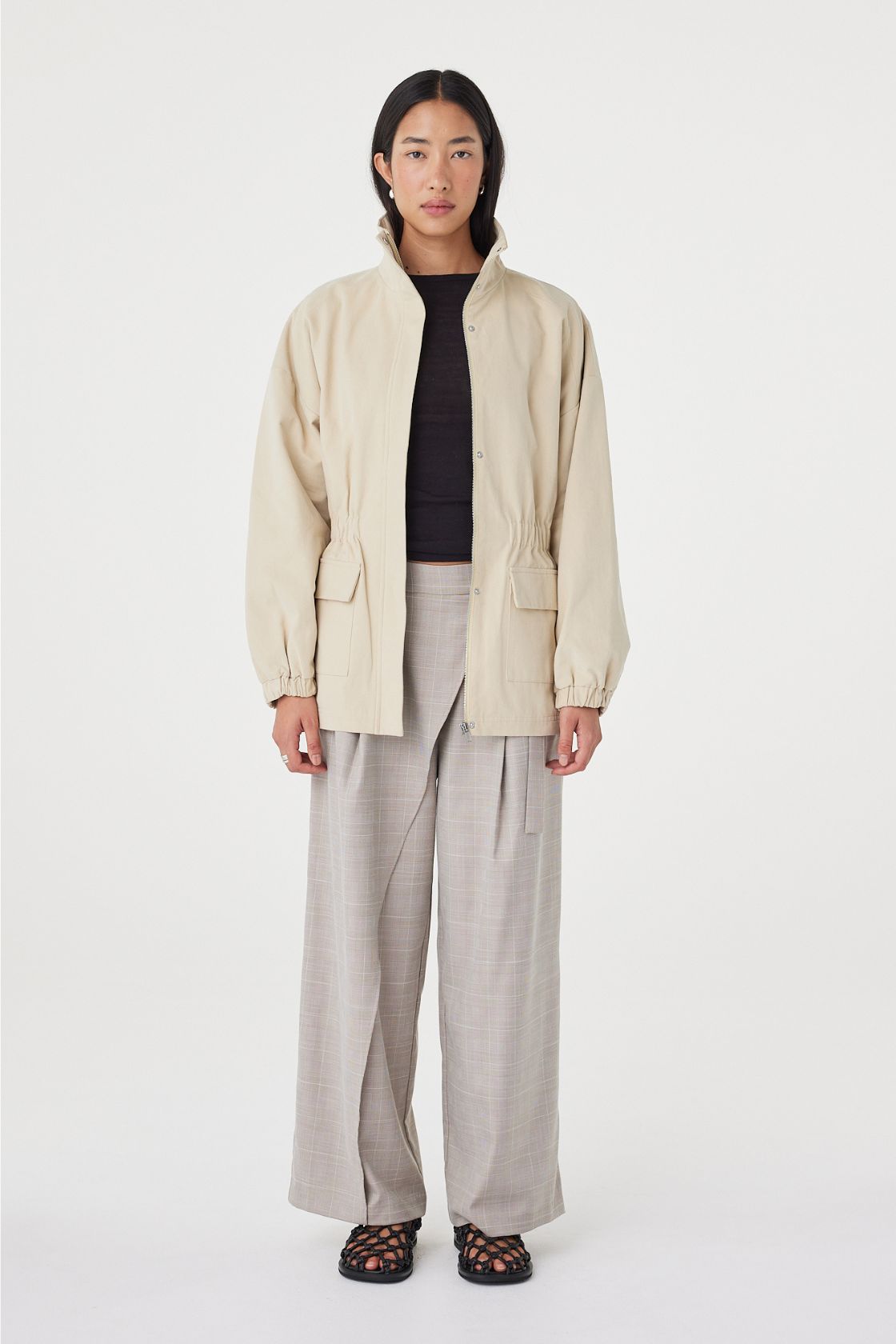 Full-length front view of the Amari Jacket in Beige styled with wide-leg trousers for an effortless everyday look.