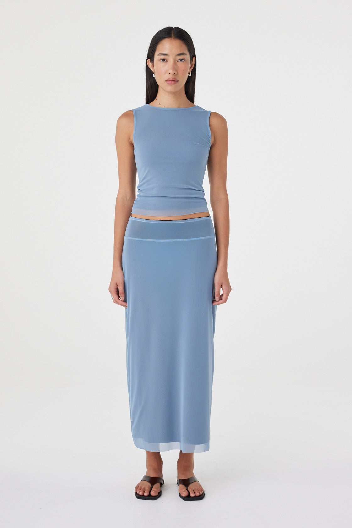 Front view of the Eden Reversible Top in Pale Blue & Espresso highlighting the pale blue side, fitted silhouette and clean neckline, paired with the matching skirt.
