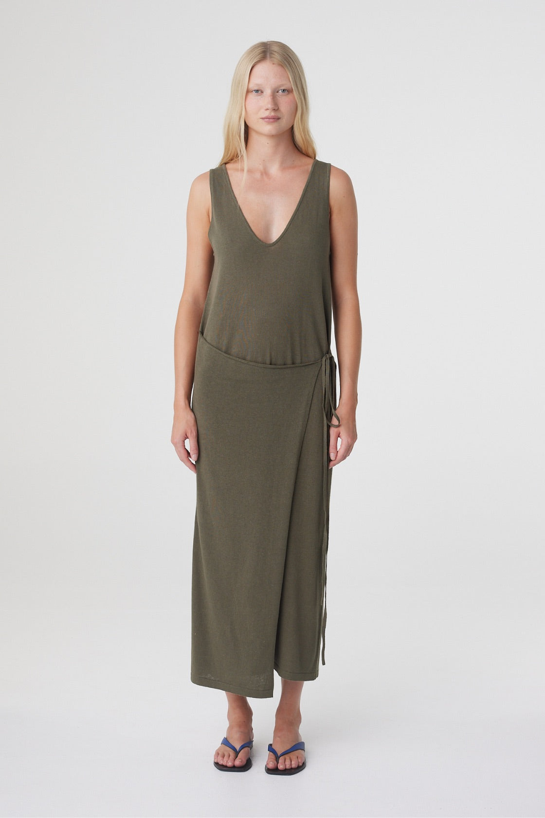 Sarina Wrap Maxi Dress in Smokey Olive, full length front view showing the deep V neckline and asymmetrical wrap detail at the waist.