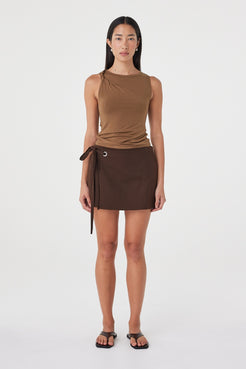 Front full-length view of the Mable Tank in Deep Cedar highlighting the body-skimming silhouette, shoulder twist and clean sleeveless shape.
