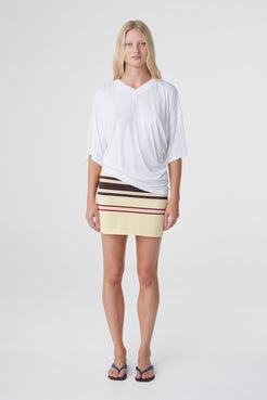Blaine Tee in White, straight on front view showing the relaxed oversized shape and draped asymmetrical hem.