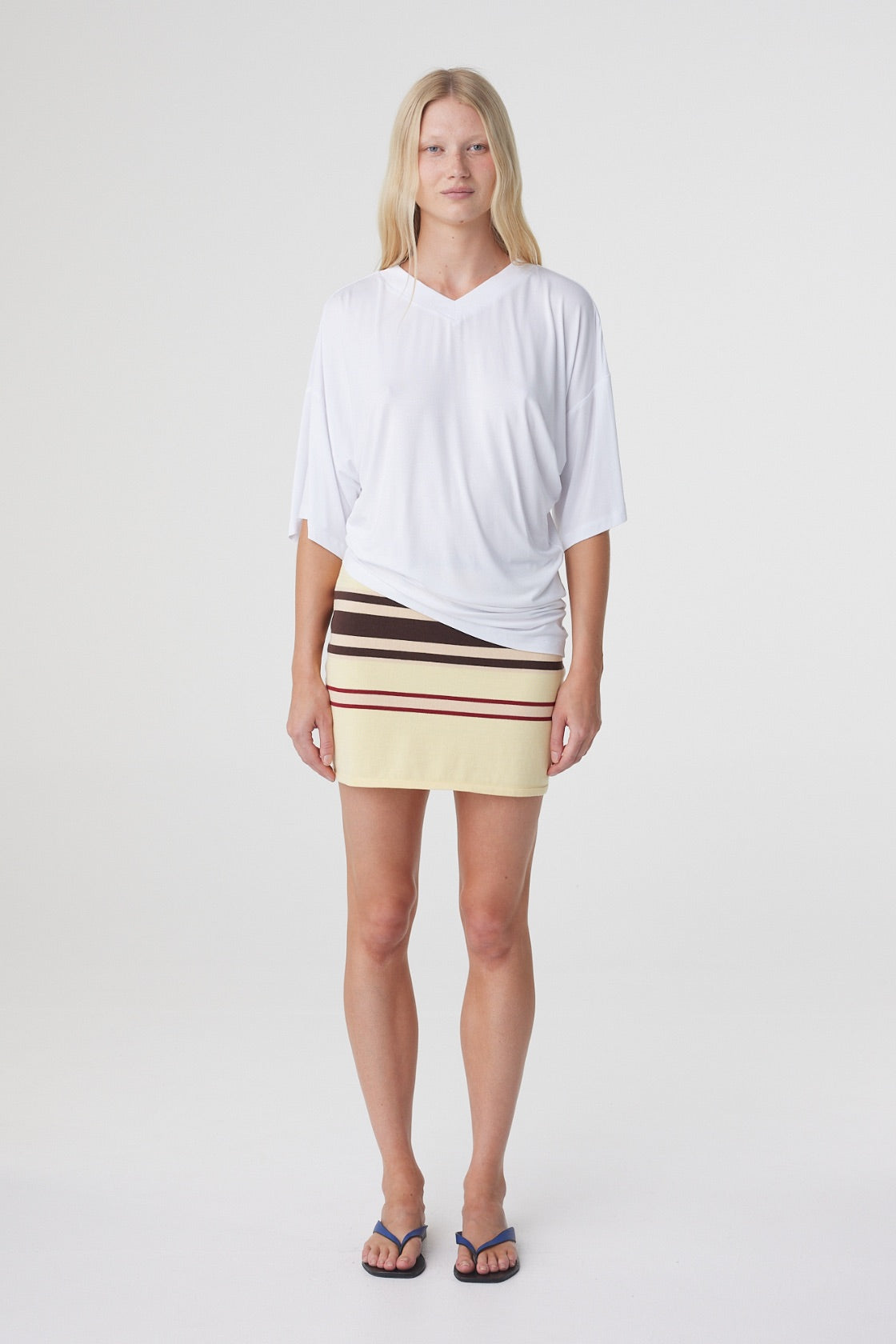 Blaine Tee in White, straight on front view showing the relaxed oversized shape and draped asymmetrical hem.