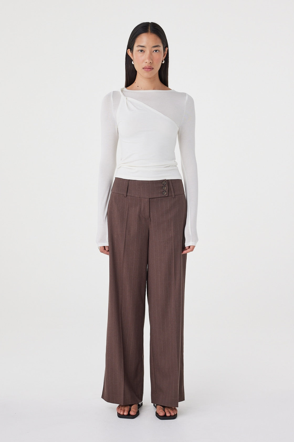 Front view of the Mabel LS Twist Top in Cream highlighting the asymmetrical neckline, soft knit texture and close-fitting silhouette.