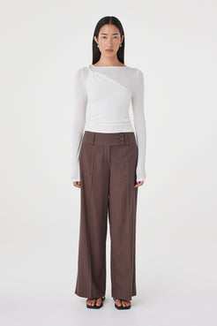 Front view of the Mabel LS Twist Top in Cream highlighting the asymmetrical neckline, soft knit texture and close-fitting silhouette.