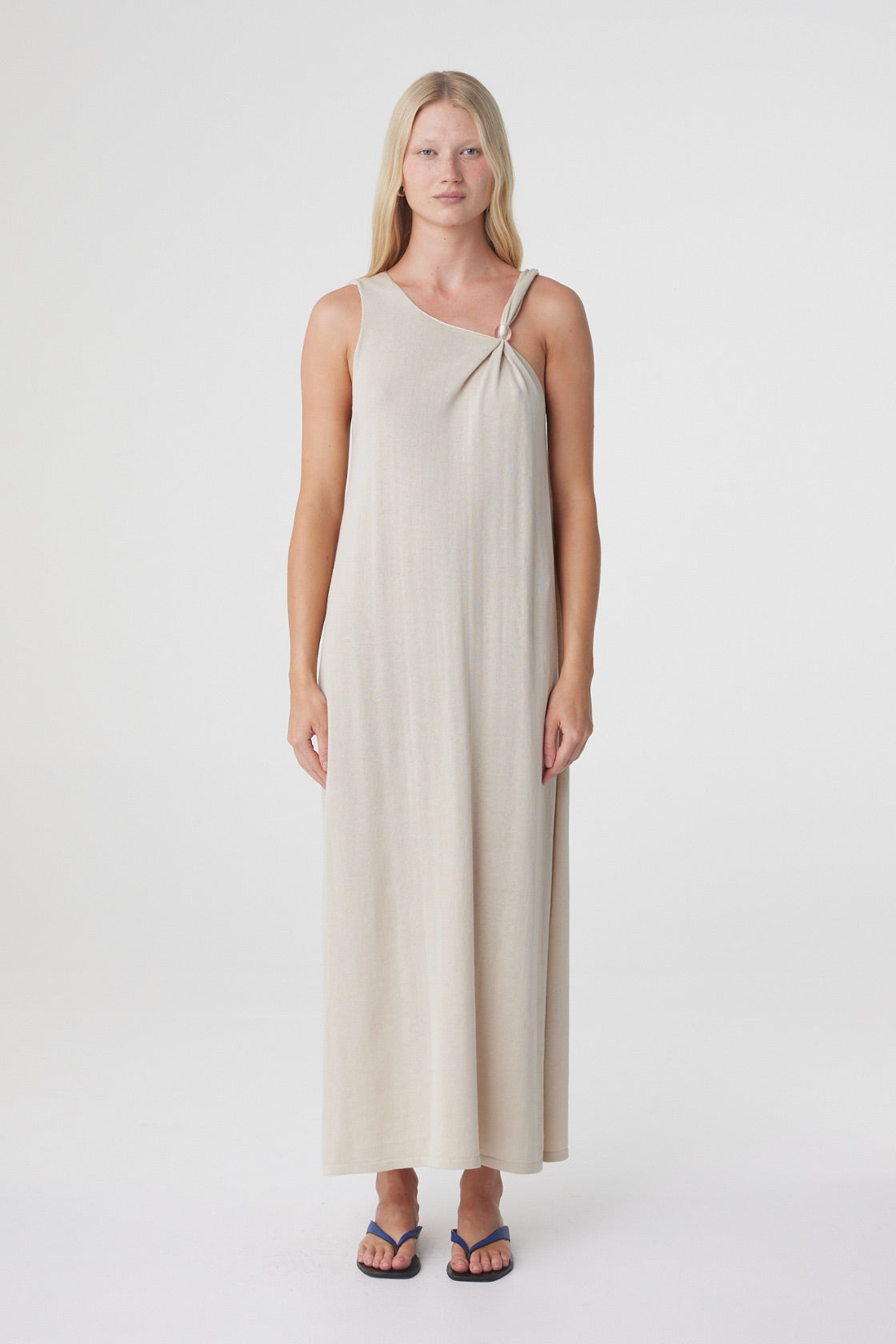 Clara Maxi Dress in Taupe, close front view showing the asymmetrical neckline and clear bead detail at the shoulder.