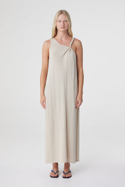 Clara Maxi Dress in Taupe, close front view showing the asymmetrical neckline and clear bead detail at the shoulder.