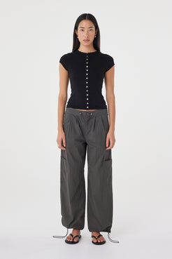 Front view of the Robbie Top in Black highlighting the smooth fine knit, button front detailing and close-fitting silhouette.