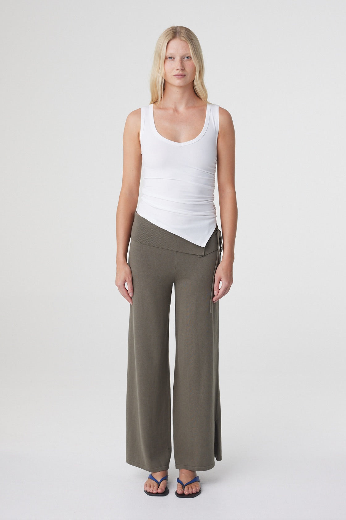 Elin Tank in Cream, straight-on front view highlighting the close fit, wide straps and asymmetric finish through the waist.