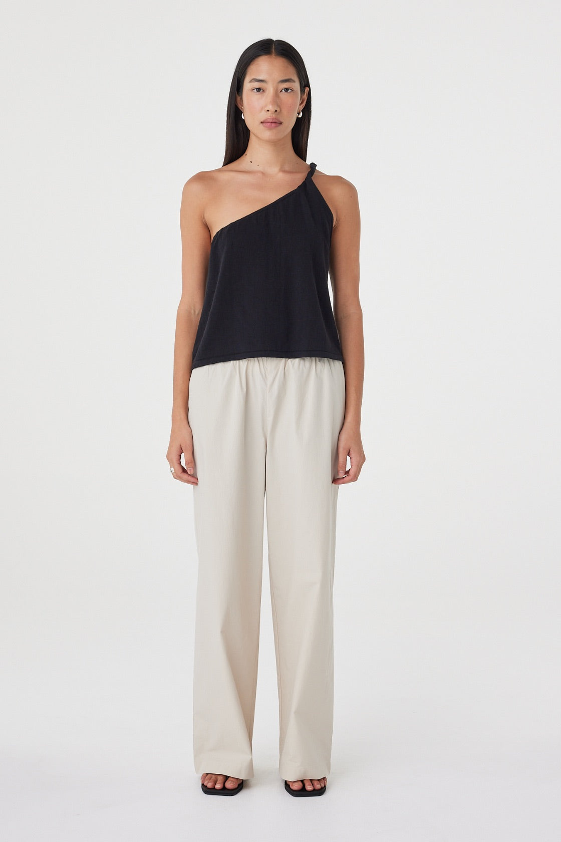 Front view of the Harri Asym Top in Black highlighting the asymmetric neckline, relaxed body and lightweight linen cotton fabrication.