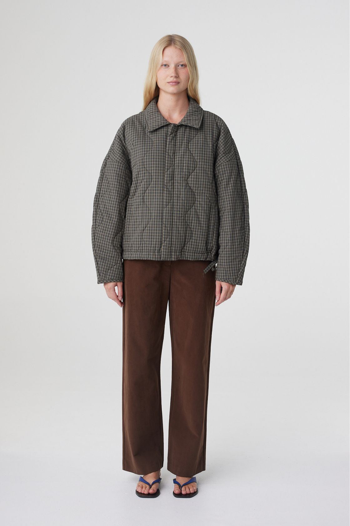 Front view of the Matteo jacket in olive and teal check showcasing the structured collar, concealed button placket and roomy silhouette designed for layering.