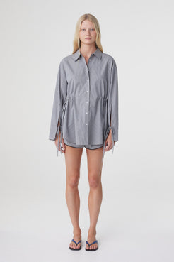 Front view of the Sia Shirt in Muted Blue Check, worn loose to show the oversized fit and longer shirt length.