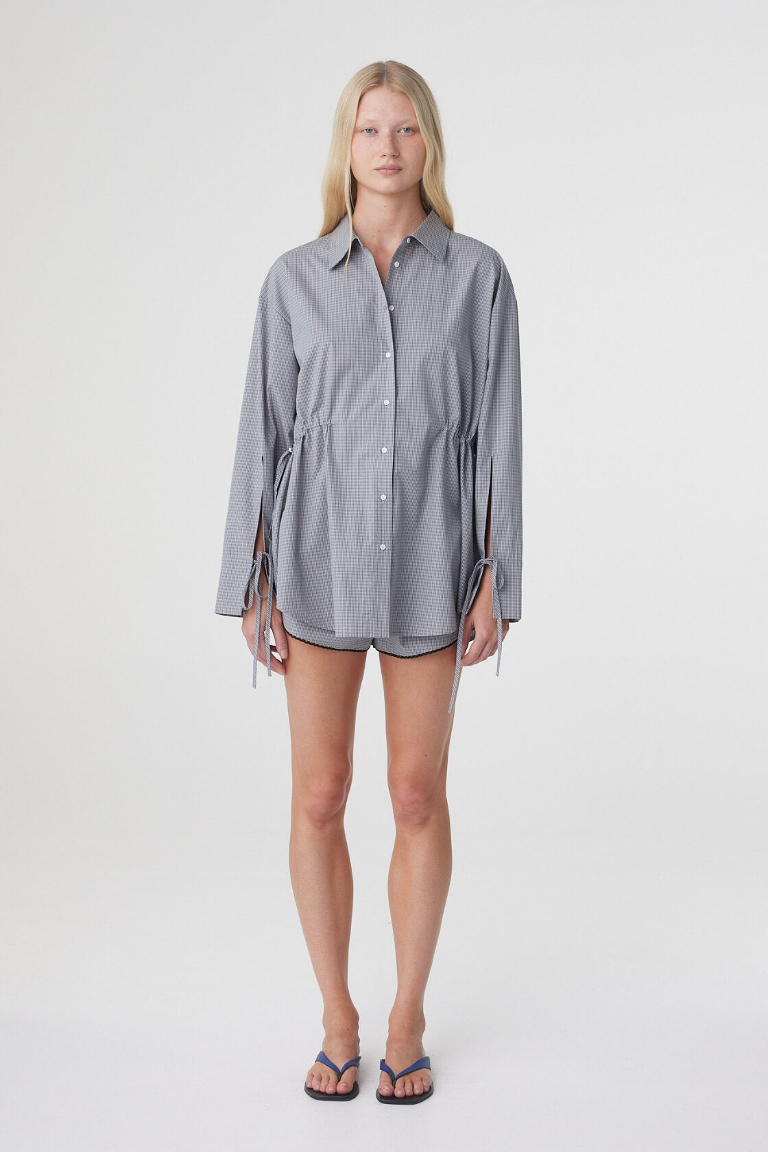 Front view of the Sia Shirt in Muted Blue Check, worn loose to show the oversized fit and longer shirt length.