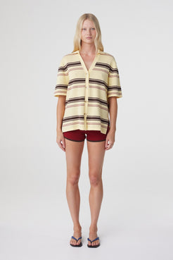 Willa Shirt in Butter Espresso Stripe, straight-on front view styled with burgundy shorts, highlighting the button through front and horizontal stripe knit.