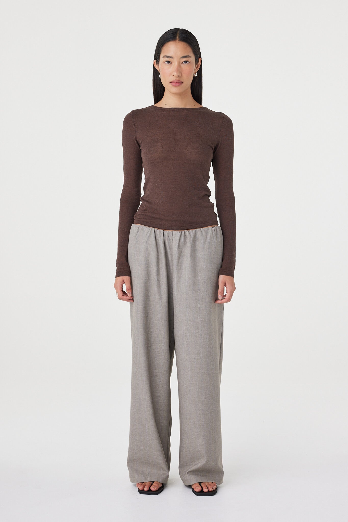 Full-length front view of the Aston LS Top in espresso showcasing the long sleeve silhouette, soft semi-sheer finish and clean boat neckline styling