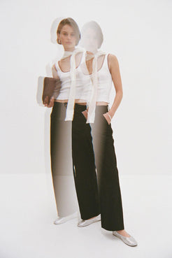 White cropped tank and black tailored trousers with layered scarf detail, minimalist elevated basics