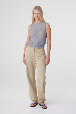 Hana Top in Mist, full length front view styled with cream trousers, showing the slim fit and ribbed hem sitting at the waist.
