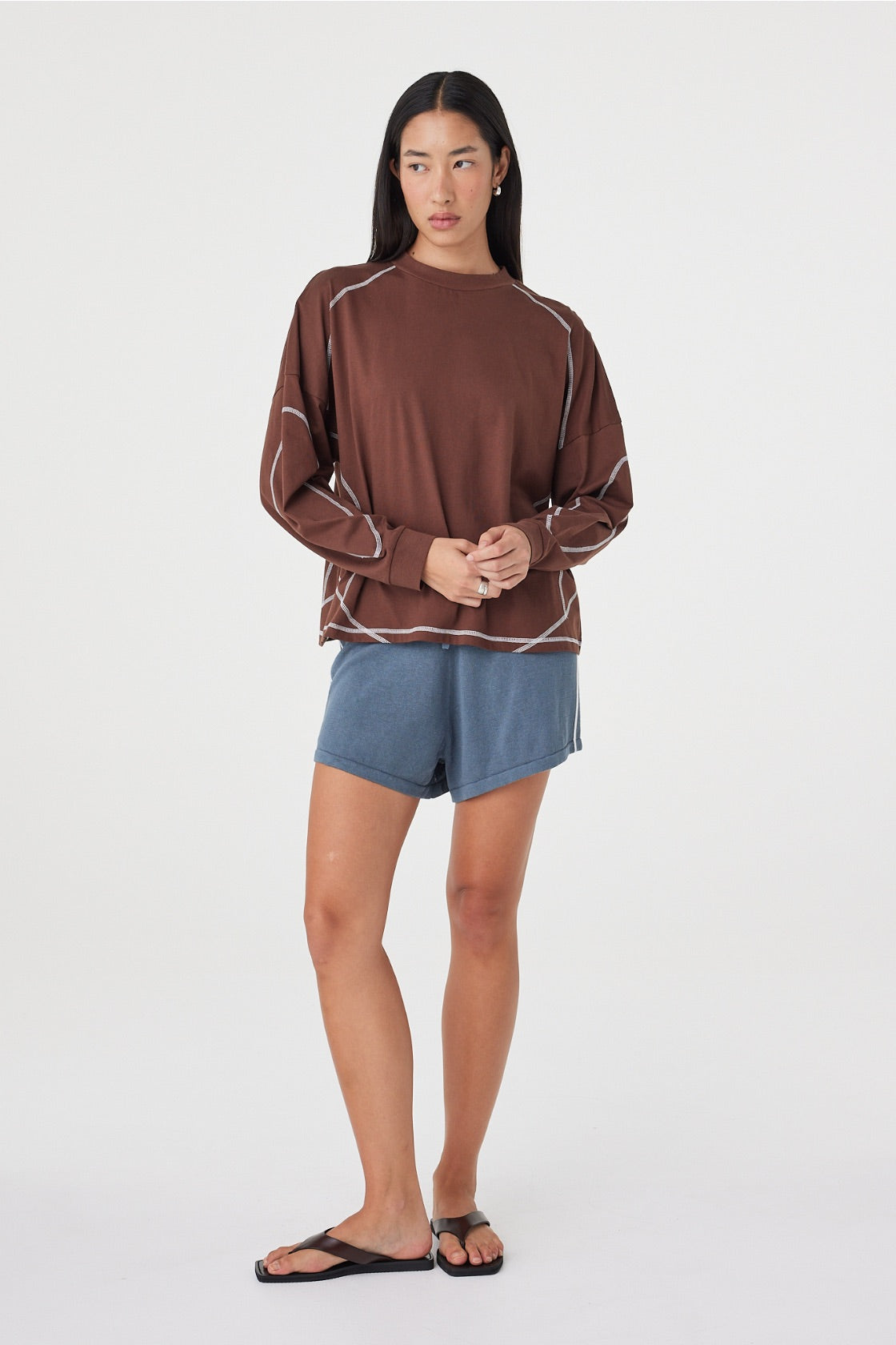 Full-length front view of the Kesh LS Tee in Espresso & Cream showcasing the relaxed fit, long sleeves and contrast stitching, paired with blue lounge shorts.