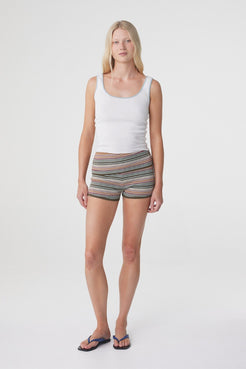 Model wearing the Tove Short in Olive Stripe with a white tank, relaxed front three quarter view.