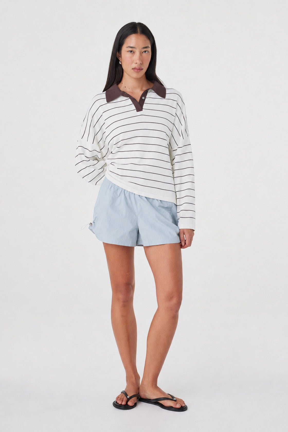 Three-quarter front view of the Addie Short in Pale Blue styled with the Zia Tie Knit Jersey in Cream Stripe, highlighting the adjustable side drawcord and relaxed silhouette.