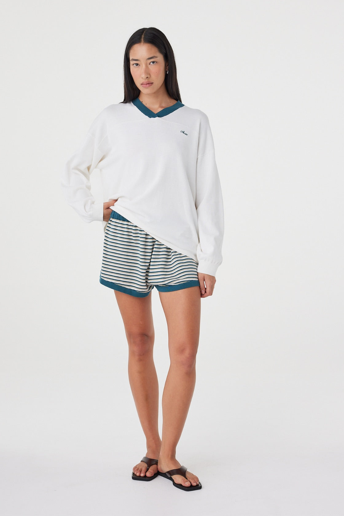 Styled full-length view of the Netta Shorts in Teal Cream Stripe paired with the Cammy LS Tee for a coordinated, sport-inspired look.