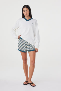 Styled full-length view of the Netta Shorts in Teal Cream Stripe paired with the Cammy LS Tee for a coordinated, sport-inspired look.