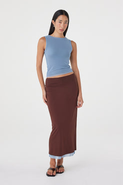 Angled front view of the Eden Reversible Skirt in Pale Blue & Espresso showcasing the espresso reverse side, slim silhouette and matching pale blue top.