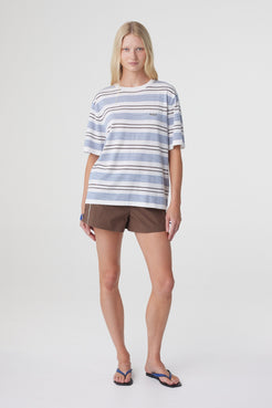 Noor Tee in White & Blue Retro Stripe, full length front view styled with brown shorts, showing the relaxed fit and short sleeve silhouette.