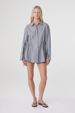 Full length front view of the Sia Shirt in Muted Blue Check, showing the relaxed long sleeve silhouette and adjustable waist.