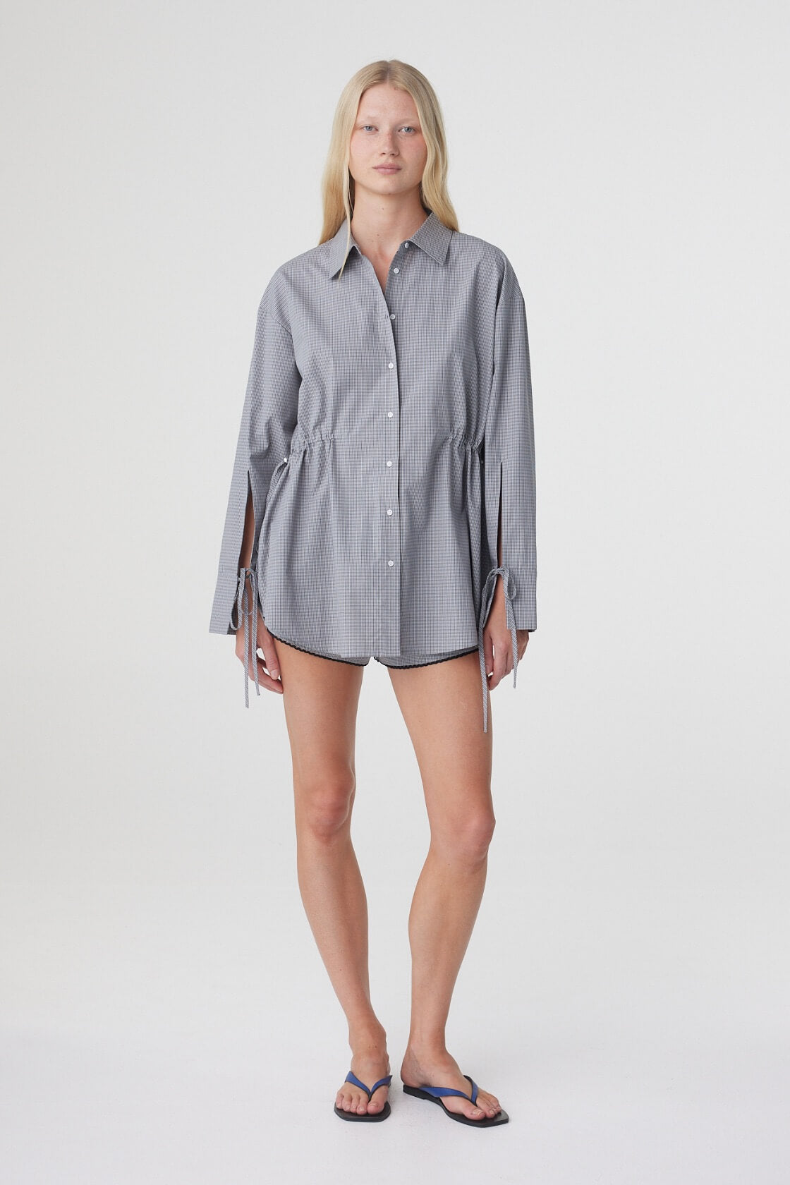 Full length front view of the Sia Shirt in Muted Blue Check, showing the relaxed long sleeve silhouette and adjustable waist.
