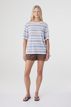 Addie Short in Espresso, relaxed full length front pose styled with an oversized striped tee and flat sandals.
