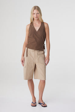 Lilia Wrap Top in Espresso, full front view styled with beige knee length shorts, showing the relaxed sleeveless silhouette.