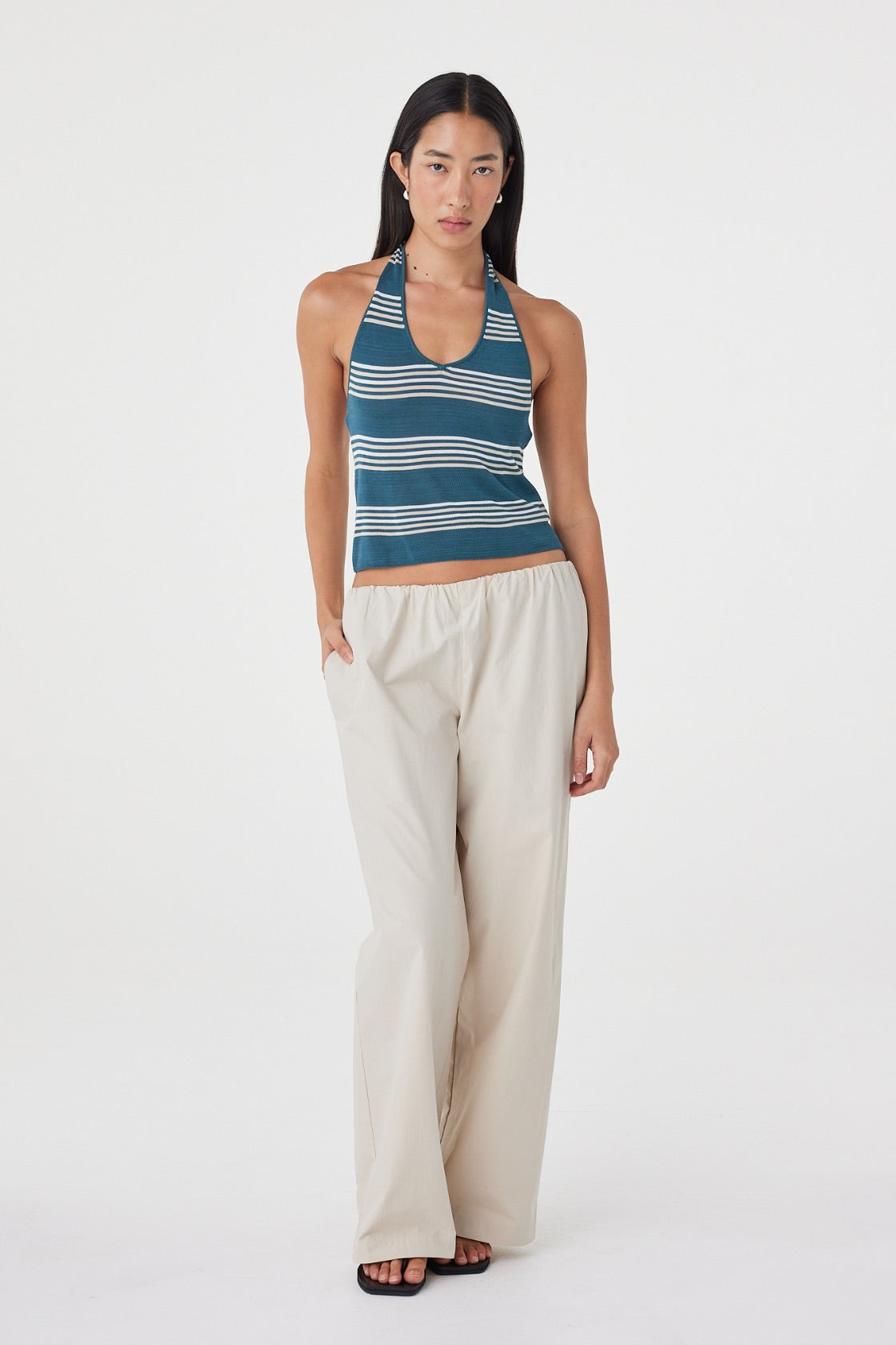 Full-length front view of the Annika Pant in Taupe styled with a striped tank and sandals, highlighting the relaxed wide leg shape.