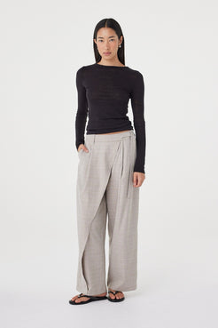 Full-length view of the  Calla Pant in Taupe Plaid styled with the Aston LS in Black and flat sandals.