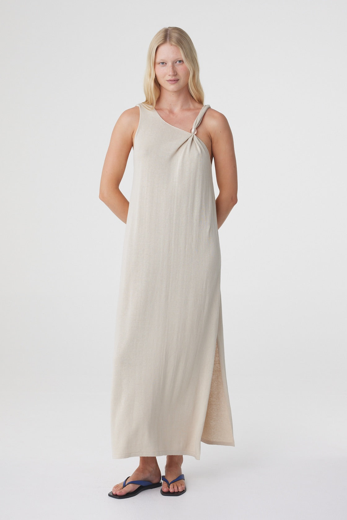 Clara Maxi Dress in Taupe, three quarter front view showing the side seam split and movement through the hem.