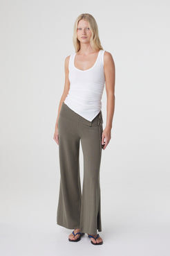 Elin Tank in Cream, full length front view styled with wide leg trousers, showing the fitted silhouette and angled hemline.