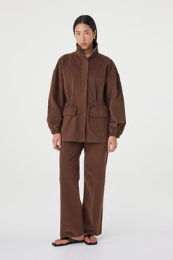 Amari Jacket in espresso styled with matching wide-leg pants and black sandals, featuring oversized front pockets, concealed zip closure and a relaxed silhouette