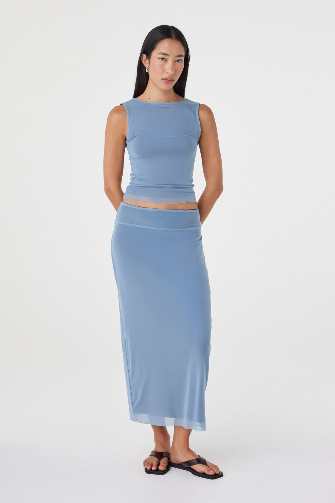Angled front view of the Eden Reversible Top in Pale Blue & Espresso highlighting the slim fit, curved neckline and reversible design, styled with the matching skirt.