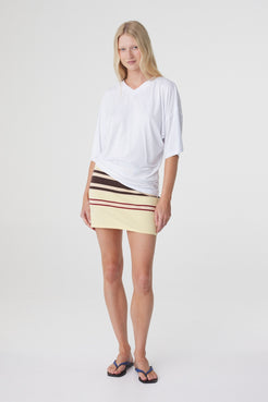 Blaine Tee in White, full length front view styled with the Mara Mini Skirt in Butter Espresso Stripe.